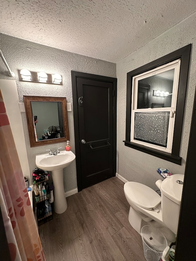 bathroom featuring toilet and hardwood / wood-style flooring