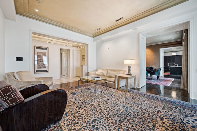 living room featuring dark hardwood / wood-style flooring and crown molding