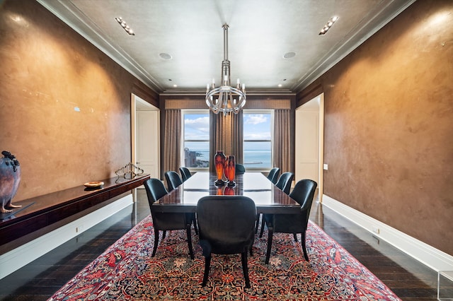 dining space with a notable chandelier, dark hardwood / wood-style floors, and crown molding