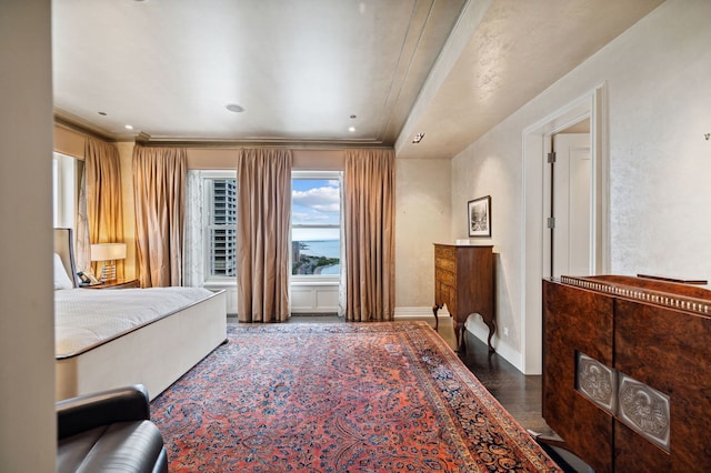 bedroom with crown molding and wood-type flooring