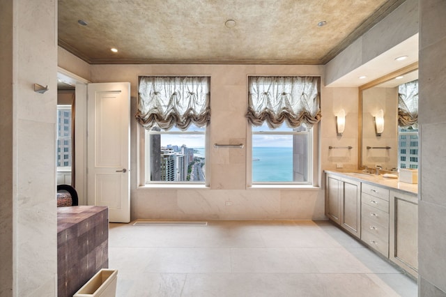 bathroom featuring crown molding and vanity