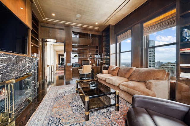 living room with wood-type flooring and built in shelves