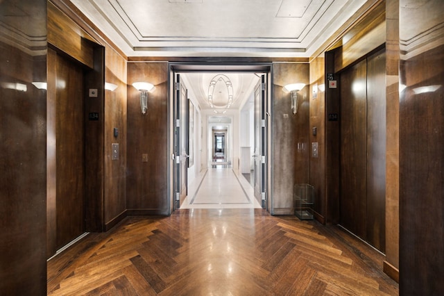 hallway featuring wood walls, dark parquet flooring, and elevator