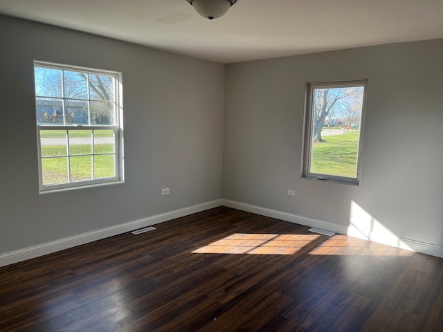 unfurnished room with dark hardwood / wood-style floors