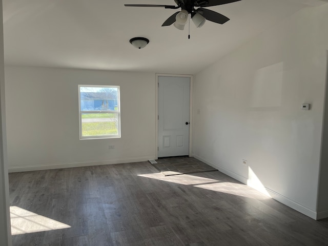 unfurnished room with ceiling fan and dark hardwood / wood-style flooring