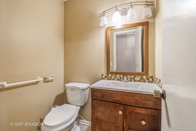 bathroom featuring decorative backsplash, vanity, and toilet