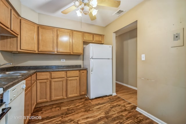 kitchen with ceiling fan, white appliances, sink, and dark wood-type flooring