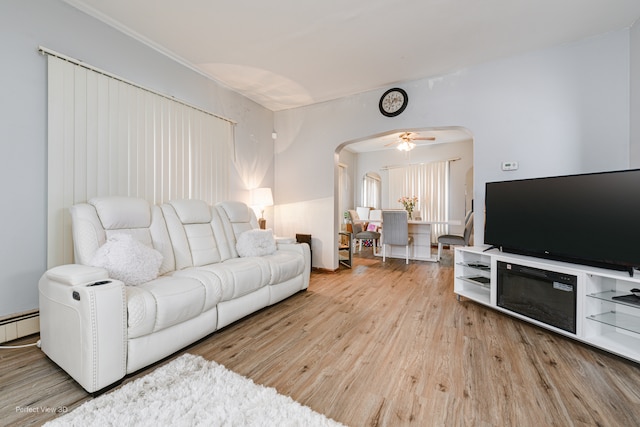 living room featuring a baseboard radiator, light hardwood / wood-style flooring, and ceiling fan