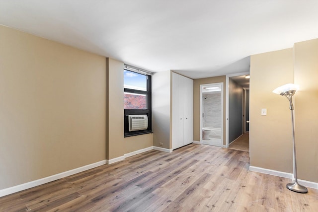 3041 S Michigan Ave Unit 504, Chicago, IL 60616 - unfurnished bedroom featuring light wood-style floors, cooling unit, and ensuite bathroom
