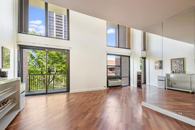 3041 S Michigan Ave Unit 504, Chicago, IL 60616 - living room with a towering ceiling, healthy amount of natural light, wood finished floors, and an AC wall unit