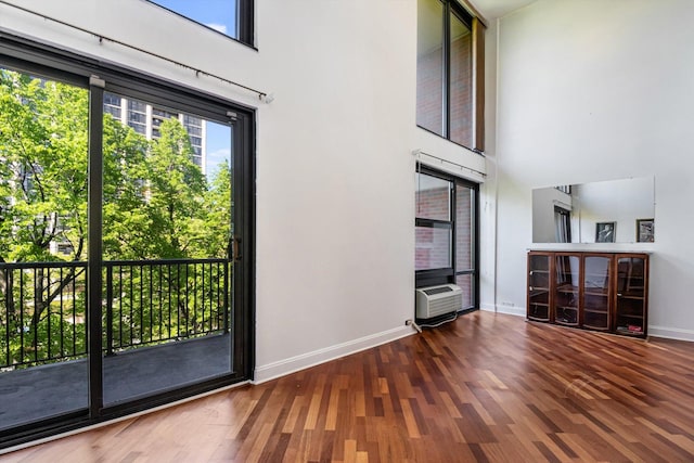 3041 S Michigan Ave Unit 504, Chicago, IL 60616 - unfurnished living room featuring a high ceiling and wood finished floors