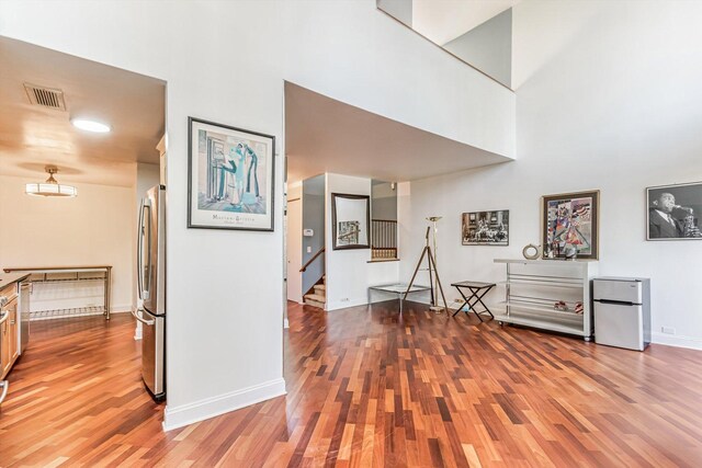 3041 S Michigan Ave Unit 504, Chicago, IL 60616 - hall featuring light wood-type flooring, a high ceiling, and stairway