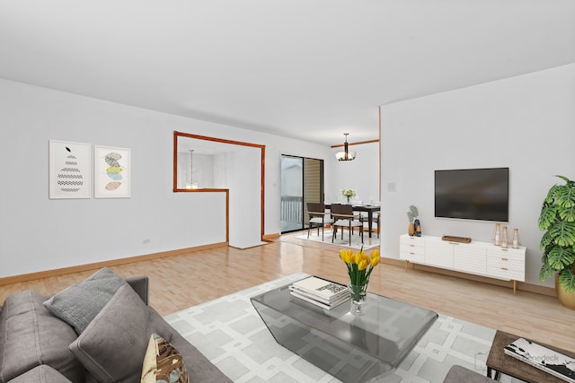 living room with hardwood / wood-style floors and a chandelier