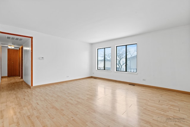 spare room with light hardwood / wood-style flooring