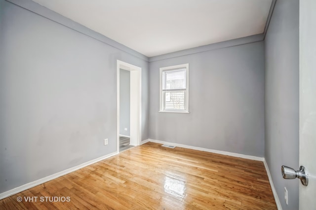 unfurnished bedroom with wood-type flooring, a fireplace, and a closet