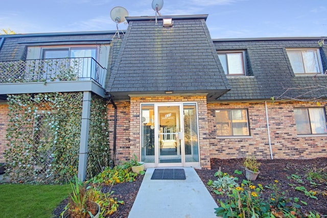830 E 191st Pl Unit 709, Glenwood, IL 60425 - entrance to property featuring mansard roof, brick siding, and a balcony