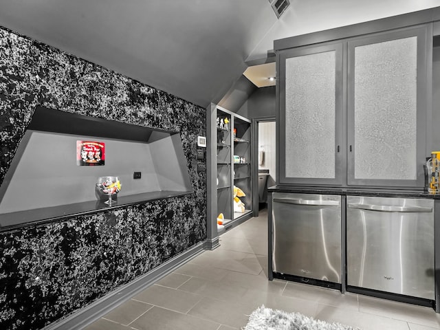 miscellaneous room featuring lofted ceiling and light tile patterned flooring