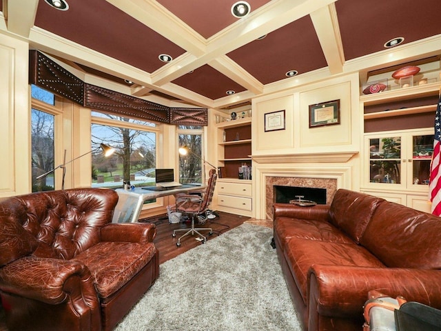 office area featuring crown molding, hardwood / wood-style flooring, beam ceiling, coffered ceiling, and built in shelves