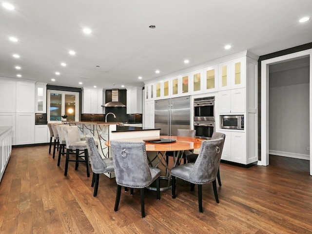 dining area with dark hardwood / wood-style floors and sink