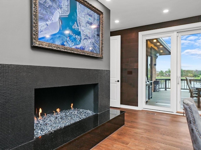 living room with hardwood / wood-style floors and a fireplace