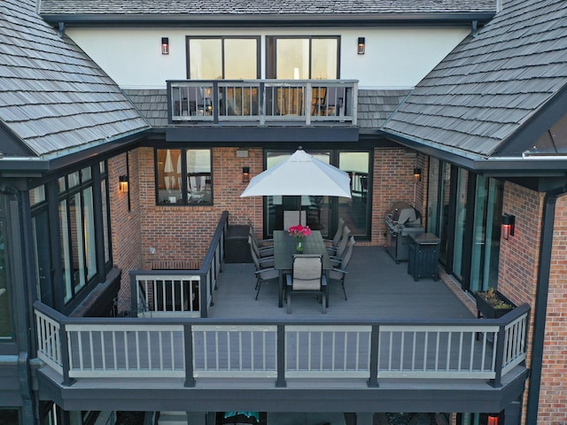 back of property featuring a balcony