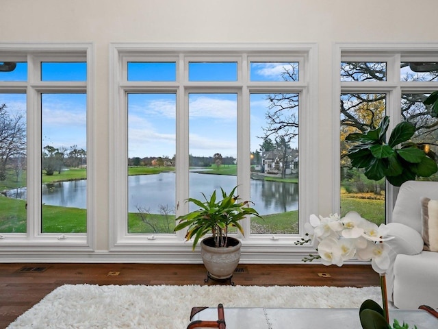 sunroom with a water view and plenty of natural light