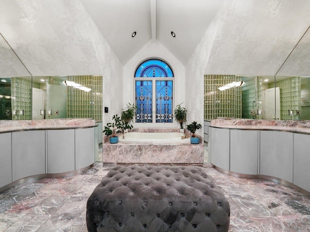 bathroom featuring vanity, beam ceiling, high vaulted ceiling, and shower with separate bathtub