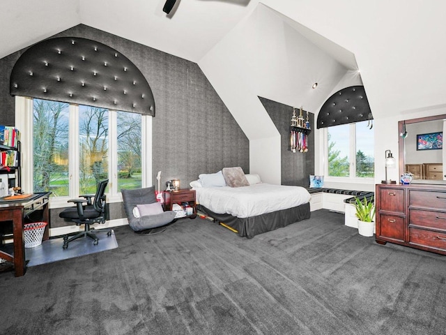 bedroom with dark colored carpet and vaulted ceiling