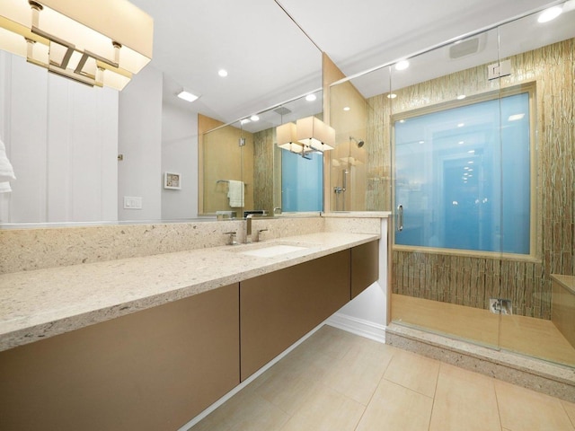 bathroom with vanity, a shower with shower door, and tile patterned flooring