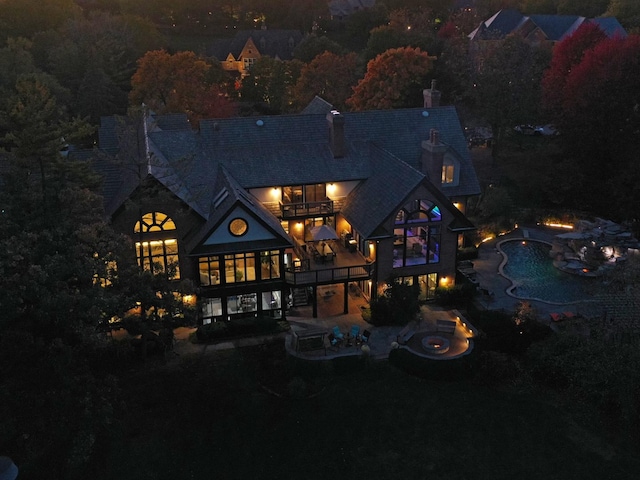 view of back house at twilight