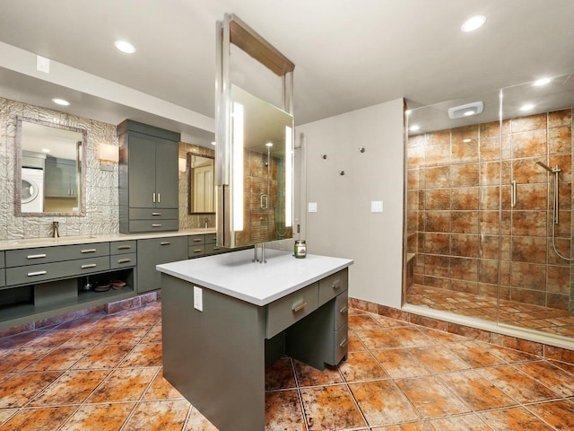 bathroom featuring vanity, tile patterned floors, and a tile shower