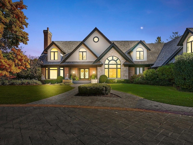 french provincial home featuring a yard