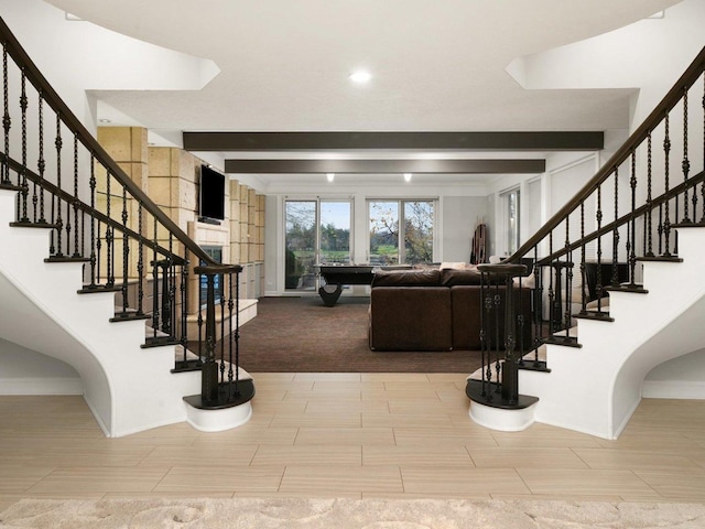 staircase featuring beamed ceiling