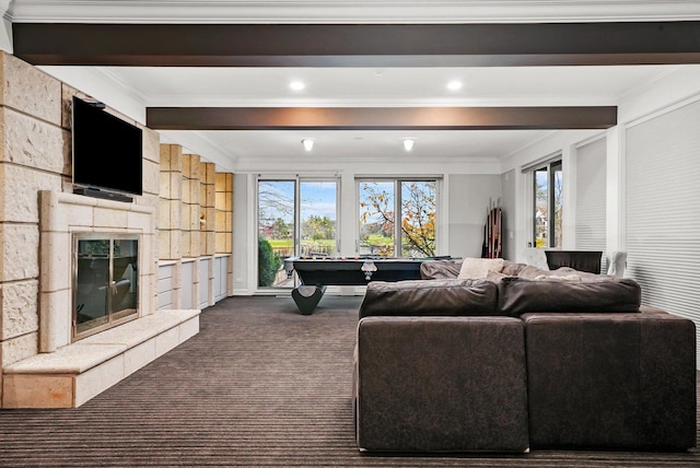 carpeted living room with crown molding, a large fireplace, and a healthy amount of sunlight