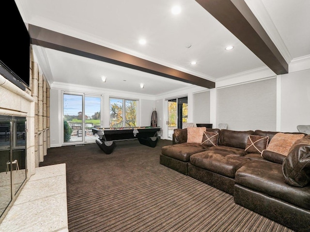 living room featuring crown molding, a fireplace, and dark colored carpet