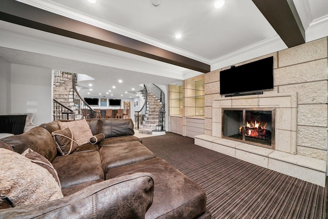 carpeted living room featuring beamed ceiling, a tile fireplace, and crown molding