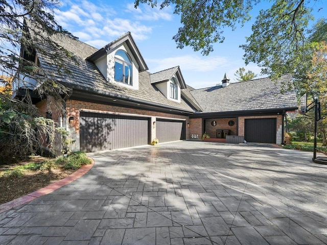 51 Hillburn Ln, North Barrington, IL 60010 - view of front of house featuring brick siding, decorative driveway, and an attached garage
