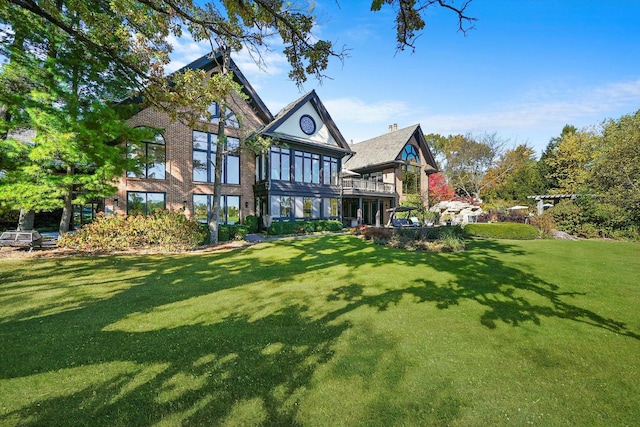 rear view of house featuring a lawn