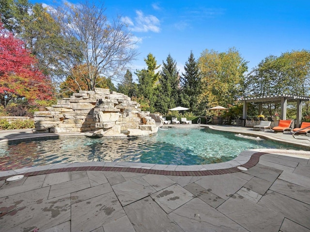 view of pool with a gazebo, pool water feature, and a patio area