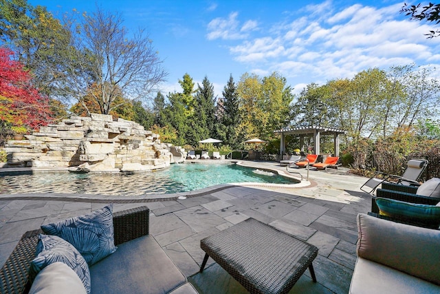 view of swimming pool featuring a patio, pool water feature, an outdoor hangout area, and a pergola