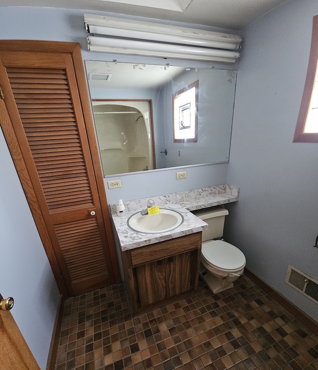 bathroom featuring vanity and toilet