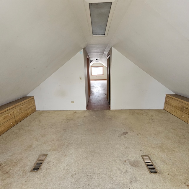 bonus room featuring carpet floors and vaulted ceiling