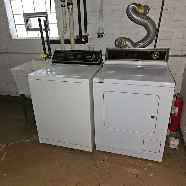 clothes washing area featuring washing machine and clothes dryer