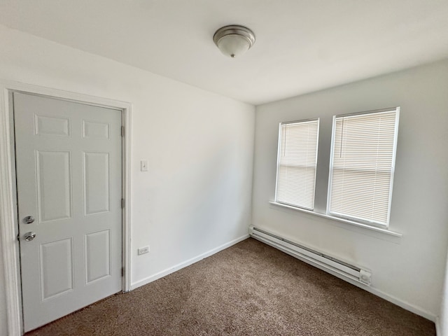 carpeted empty room featuring a baseboard radiator