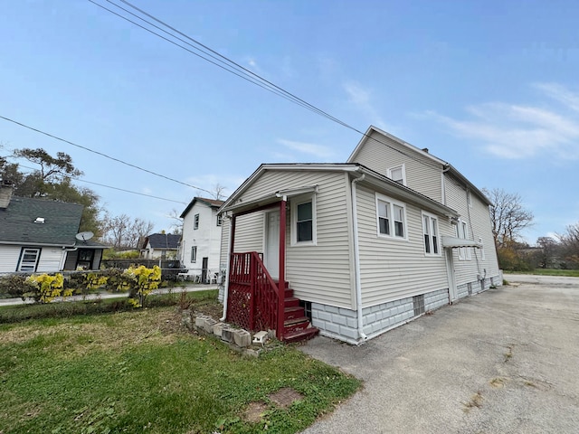 view of side of home featuring a lawn