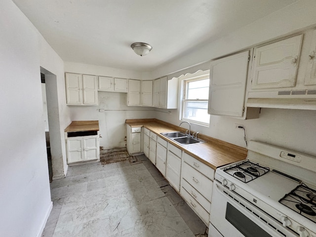 kitchen with white cabinetry, gas range gas stove, and sink