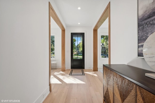 doorway featuring plenty of natural light and light hardwood / wood-style flooring