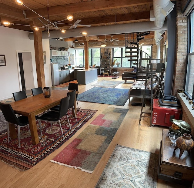 dining area featuring ceiling fan, wooden ceiling, beamed ceiling, hardwood / wood-style floors, and washer and dryer