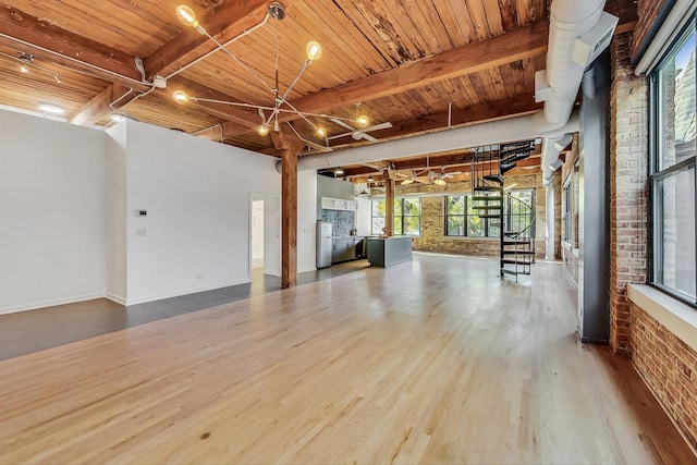 interior space with hardwood / wood-style floors, wood ceiling, beamed ceiling, and brick wall