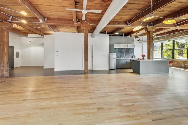 interior space featuring beamed ceiling, ceiling fan, wooden ceiling, and hardwood / wood-style flooring